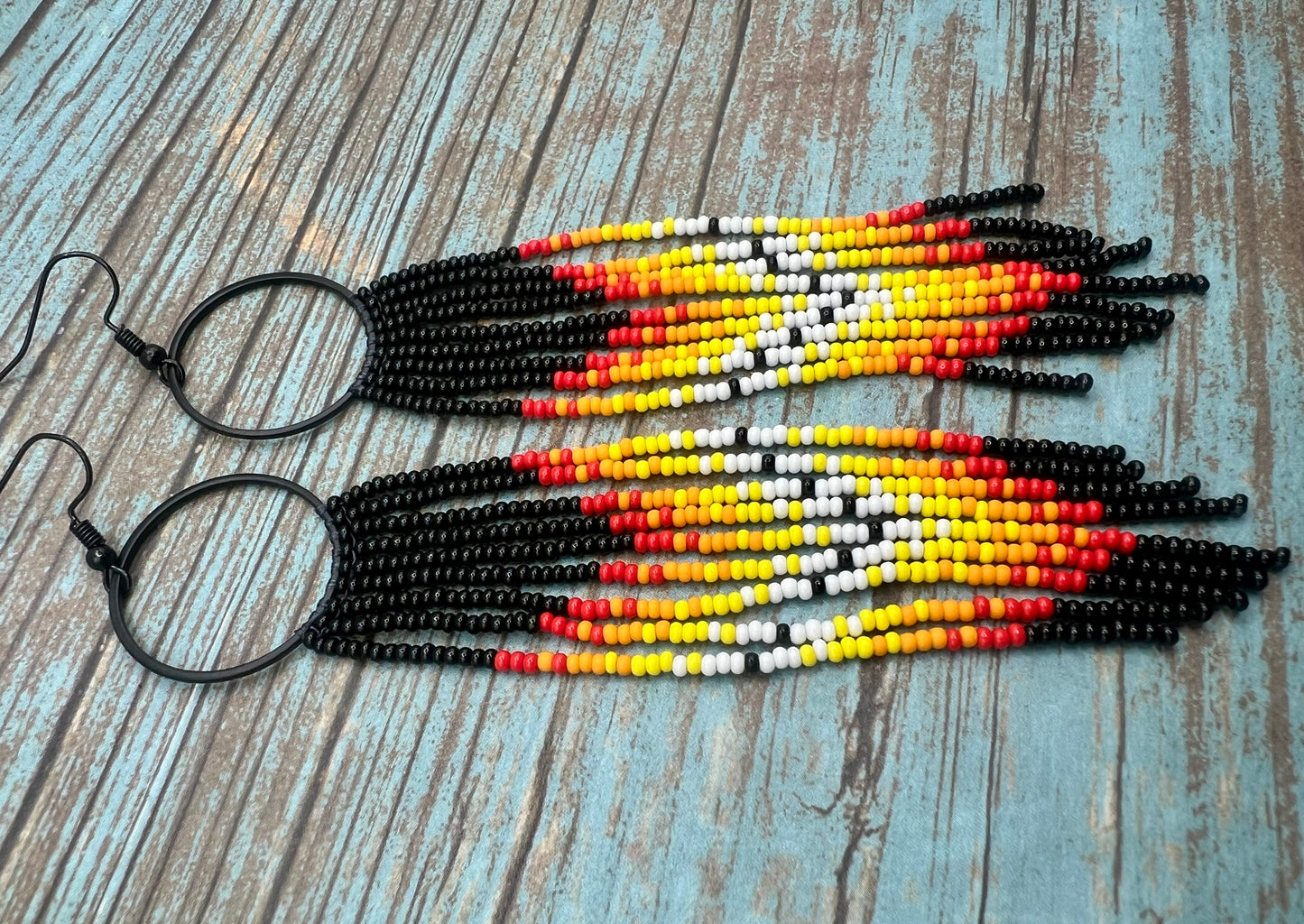 Black beaded fringe hoop and red ombré dangle earrings